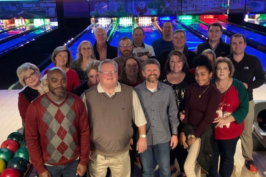 Meet the Team - Agency Owners and Comapny Team Portrait at a Bowling Alley Celebrating Their Christmas Party