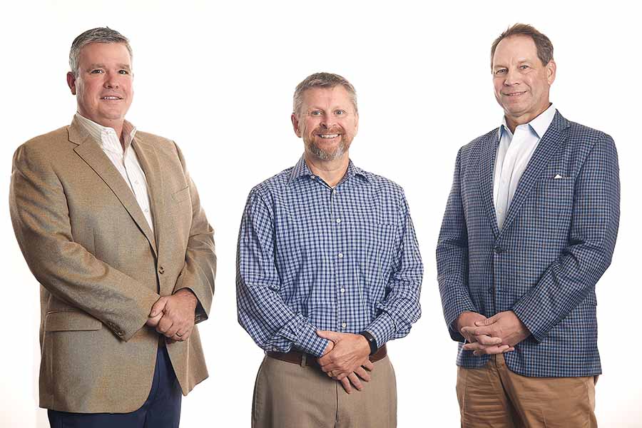 Meet Our Team - Charles McCollum, David Cherry, and Charlie Fister Standing and Smiling Together as the Three Owners of Manry Heston Agency